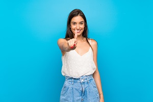 packers and movers - Young woman over isolated blue background showing and lifting a finger
