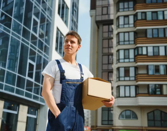 Mover holding a cardboard box under his arm