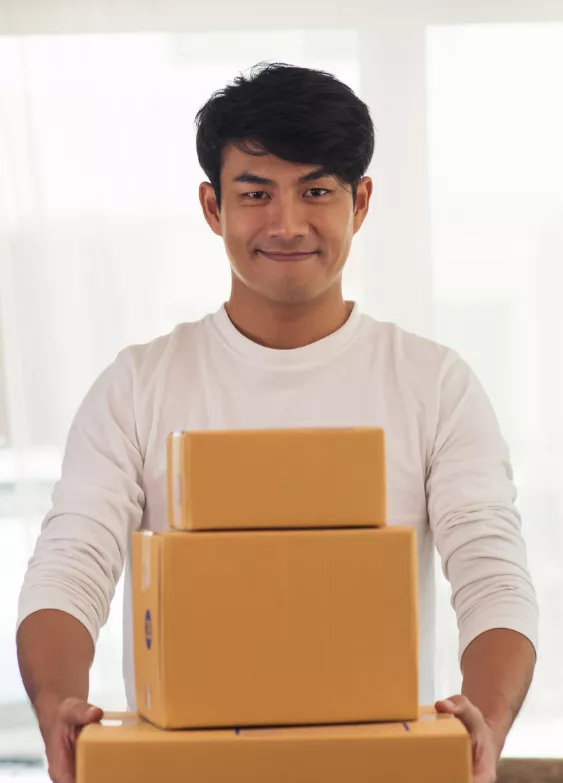 Man holding stacked cardboard boxes