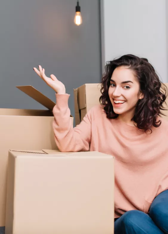 Woman leaning on cardboard boxes