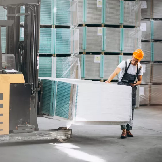 Storage worker dragging a pallete of items